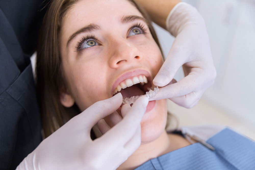 A dentist examining a patient's mouth.