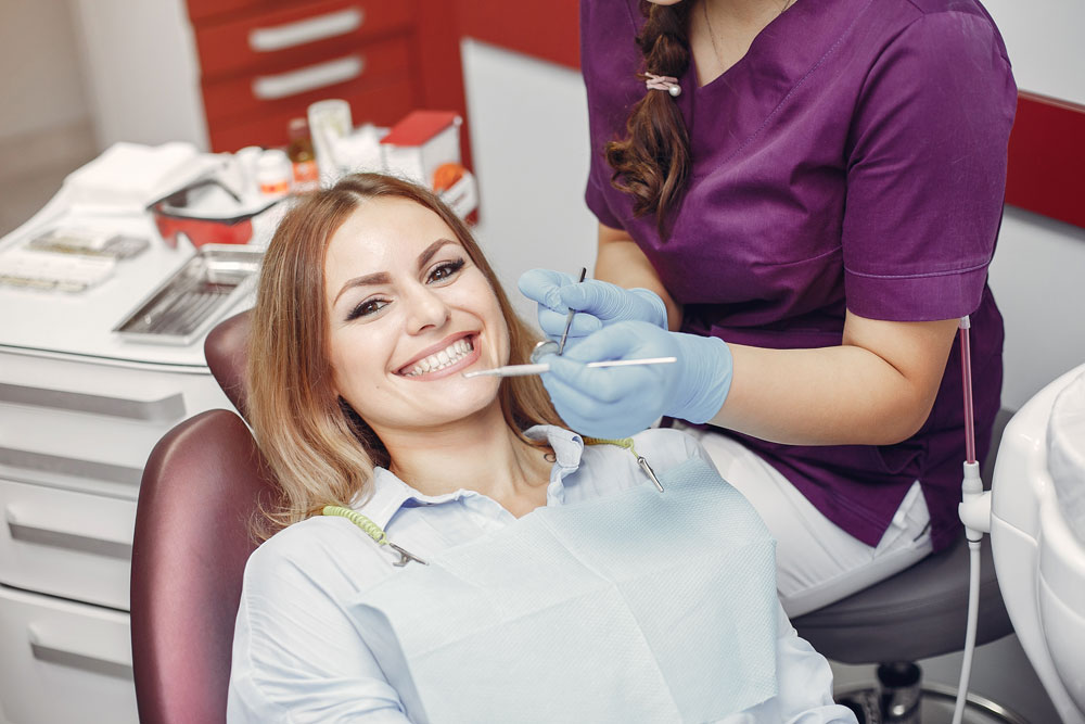 A dentist examining a patient's mouth.