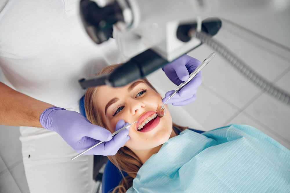 A dentist examining a patient's mouth.