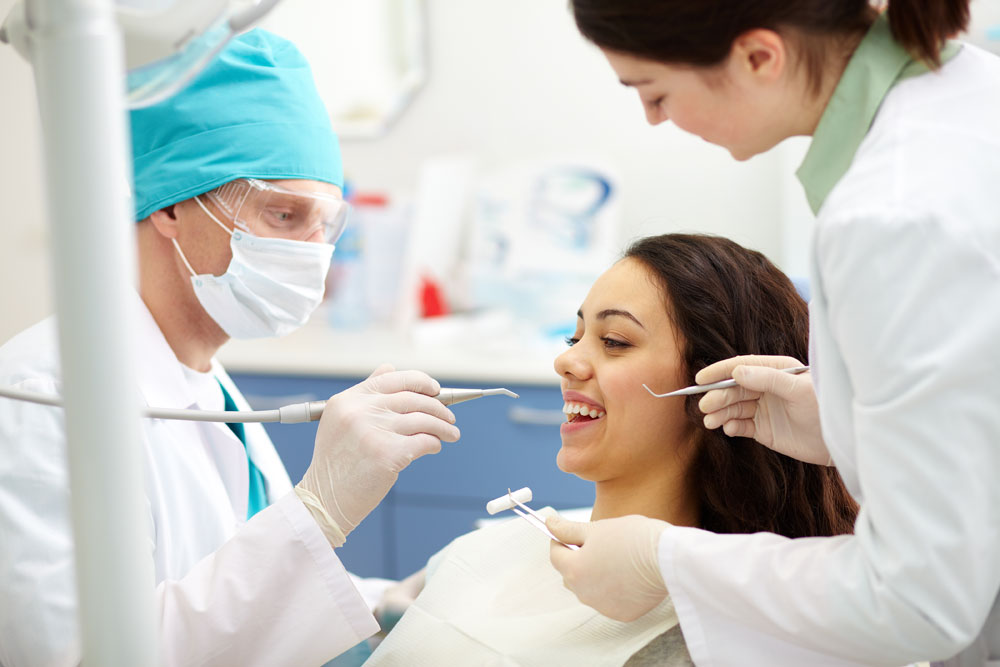 A dentist examining a patient.