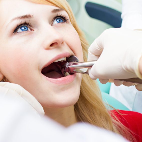 A woman sitting in a dentist's chair.