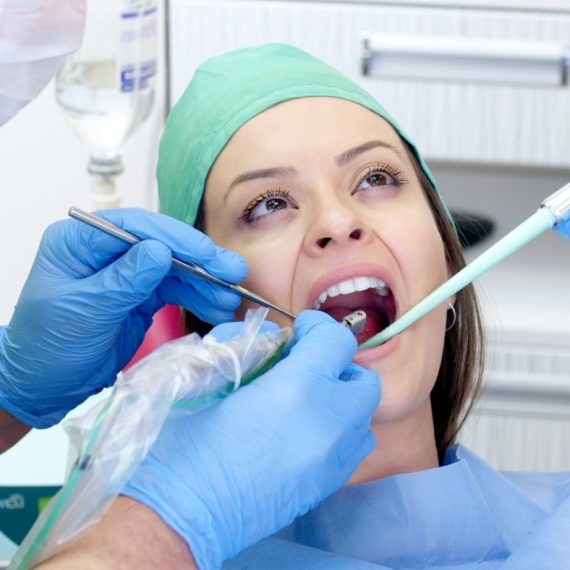 A woman sitting in a dentist's chair.